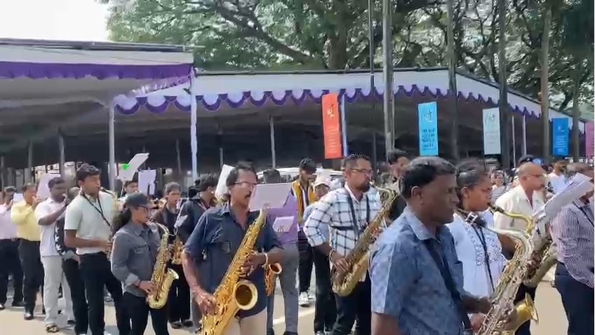 100-member brass band to tail carriage of St Xavier’s relics