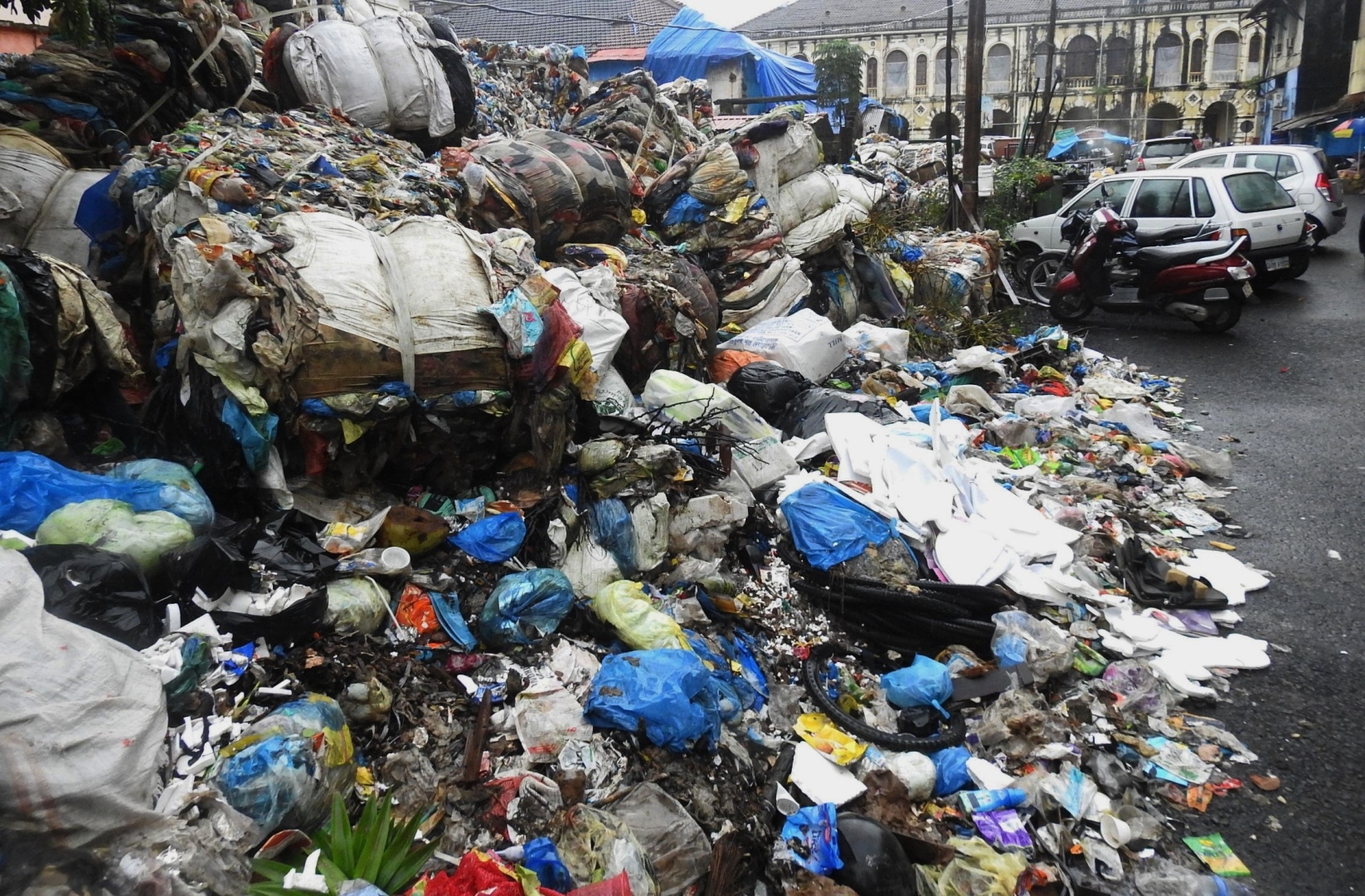 Baled waste dumped at old fish market spills onto the road