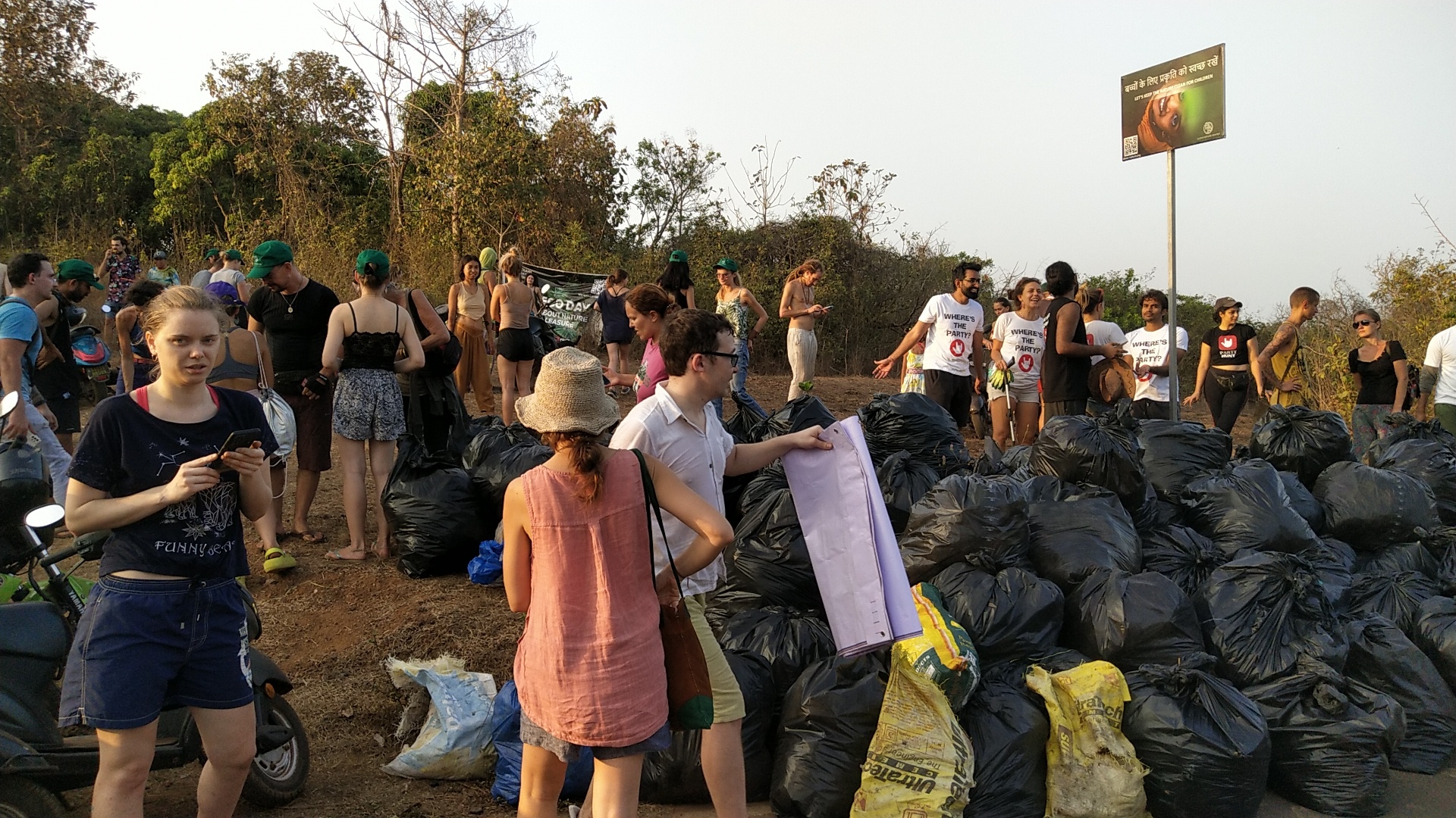 Foreign tourists collect garbage  at Arambol beach, roadsides